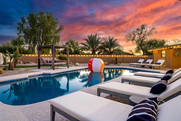 Scottsdale short-term rental with luxury pool, lounge chairs, and sunset views — managed by Arizona STR Management.